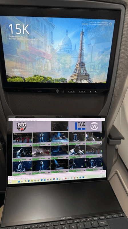 A laptop screen on a plane displaying the TAG multiviewer interface, monitoring real-time streaming latency during Super Bowl LIX powered by Witbe’s real-device monitoring technology.